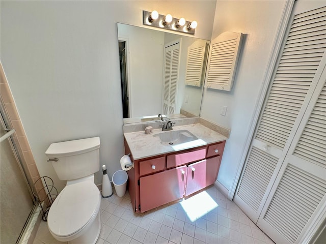 bathroom featuring vanity, toilet, and tile patterned floors