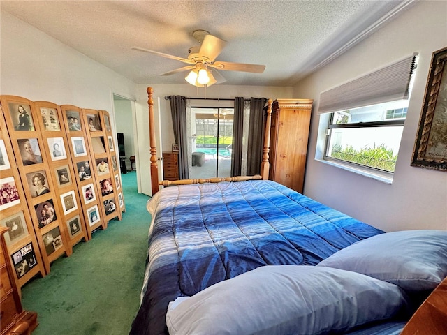 carpeted bedroom featuring a textured ceiling and ceiling fan