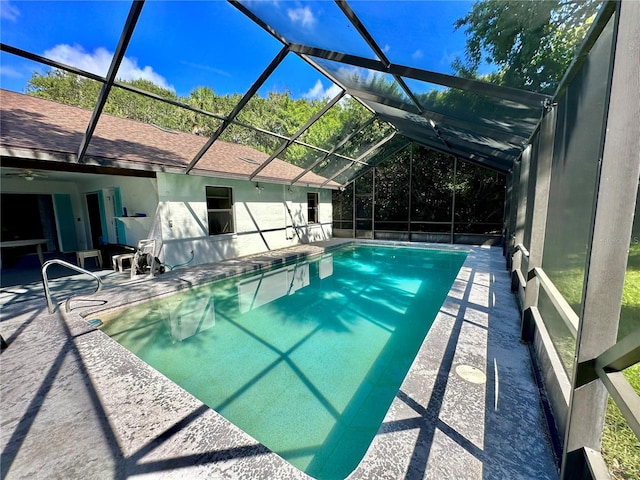 view of swimming pool with a patio area and a lanai