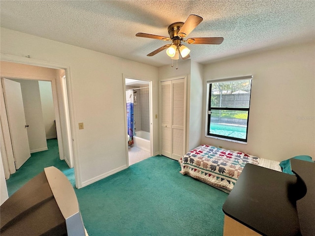 interior space featuring ensuite bath, a textured ceiling, ceiling fan, and a closet