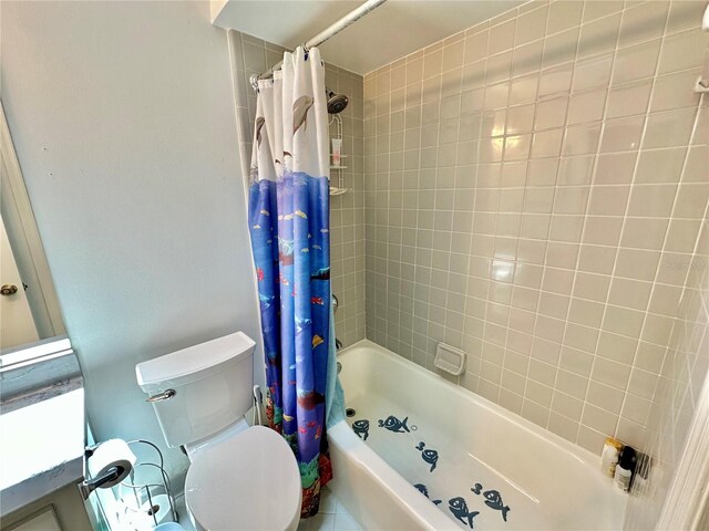 bathroom with shower / bath combo with shower curtain and toilet