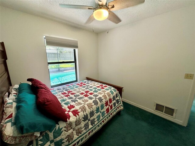 carpeted bedroom featuring a textured ceiling and ceiling fan