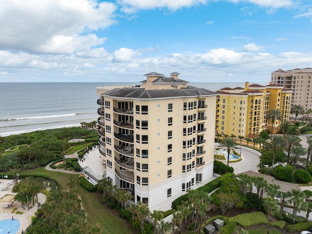 exterior space featuring a water view and a beach view