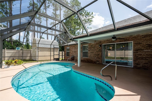 view of pool featuring a lanai, ceiling fan, and a patio area