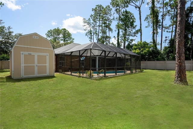 view of yard with a fenced in pool, a lanai, and a storage shed