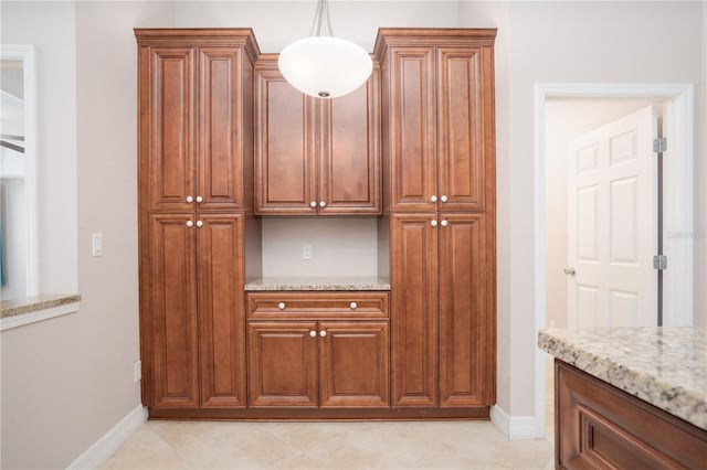 kitchen with pendant lighting and light stone countertops