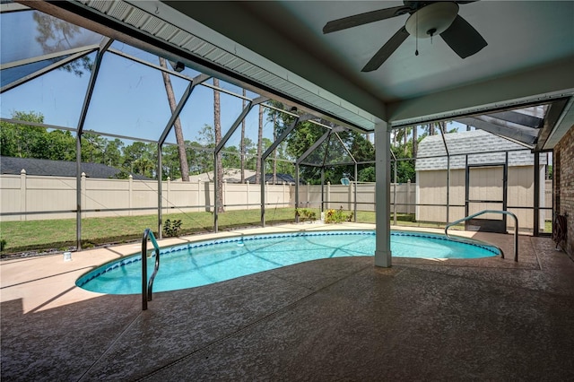 view of swimming pool with a patio, ceiling fan, and glass enclosure