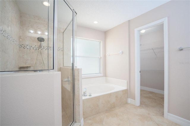 bathroom with plus walk in shower and tile patterned flooring