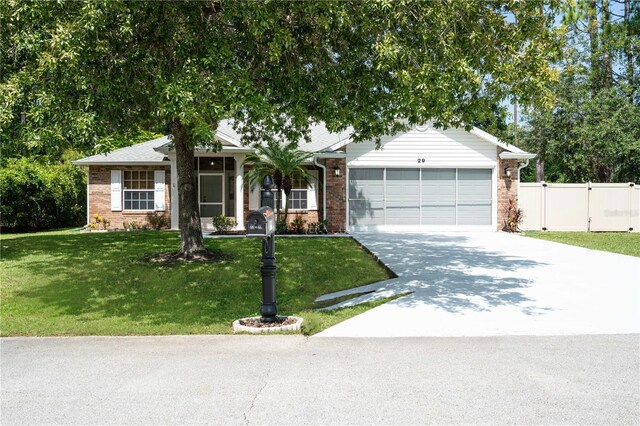 ranch-style house featuring a garage and a front lawn