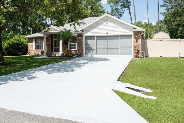 ranch-style home featuring a garage and a front yard