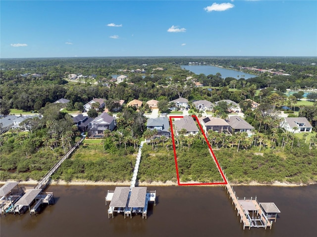 birds eye view of property with a residential view and a water view