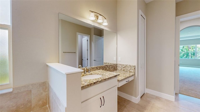 full bathroom with baseboards, vanity, and tile patterned floors