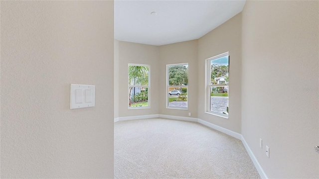 spare room with carpet flooring and baseboards