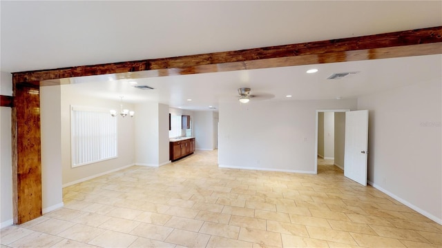 empty room featuring visible vents, baseboards, and ceiling fan with notable chandelier