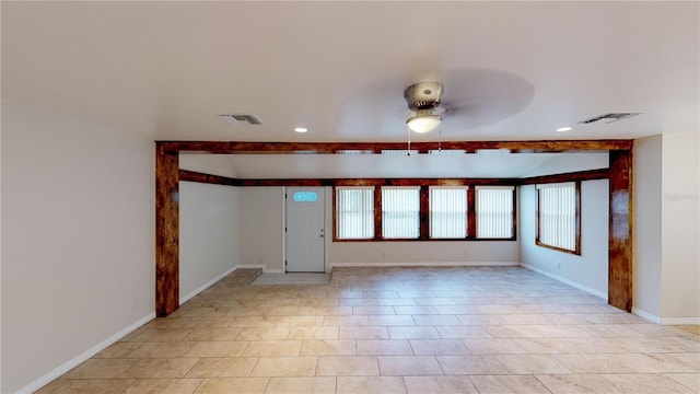 unfurnished room featuring baseboards, visible vents, and a ceiling fan