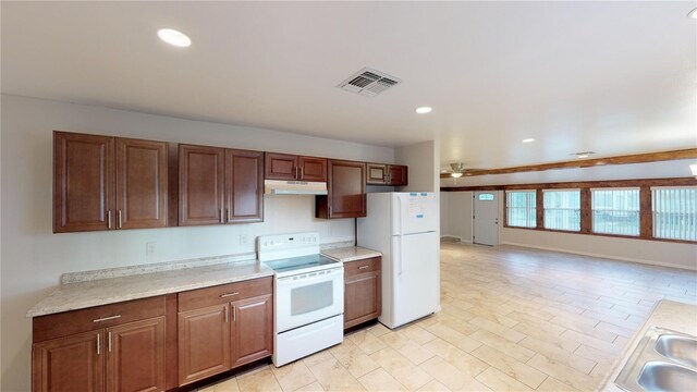 kitchen featuring recessed lighting, under cabinet range hood, white appliances, a sink, and visible vents