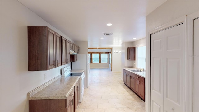 kitchen with white electric stove, visible vents, light countertops, a sink, and recessed lighting