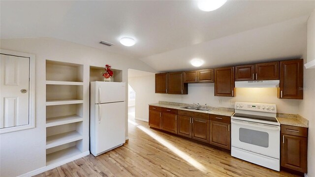 kitchen featuring under cabinet range hood, white appliances, a sink, visible vents, and light countertops