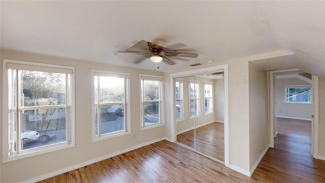 unfurnished sunroom featuring ceiling fan and visible vents