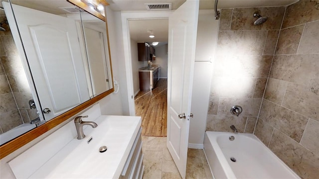 full bathroom featuring shower / bath combination, visible vents, and vanity