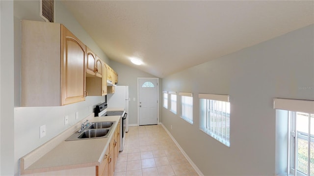 kitchen with plenty of natural light, range with electric cooktop, light countertops, and light brown cabinetry