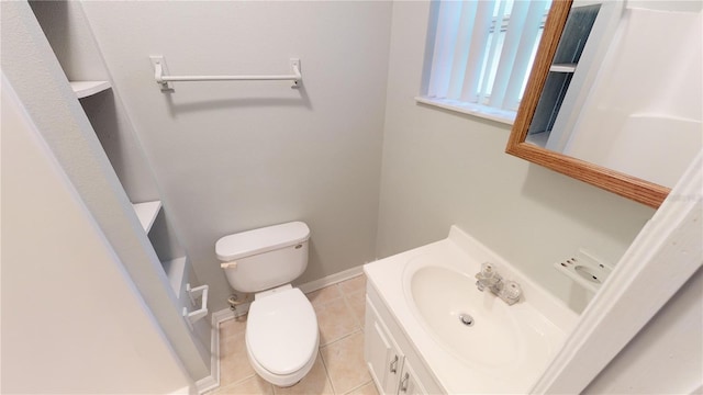 bathroom featuring tile patterned flooring, baseboards, vanity, and toilet