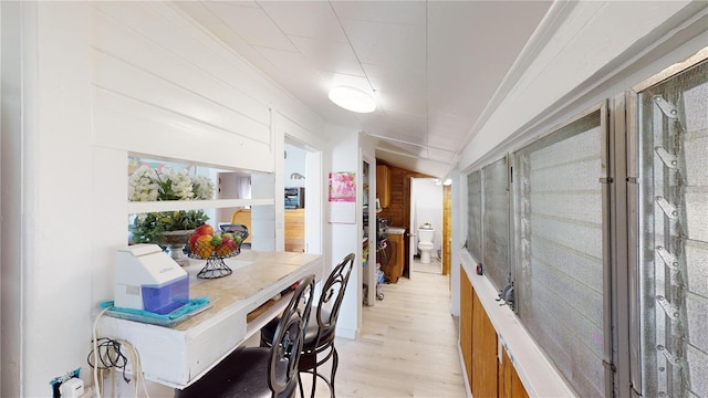 dining space with lofted ceiling and light wood-type flooring