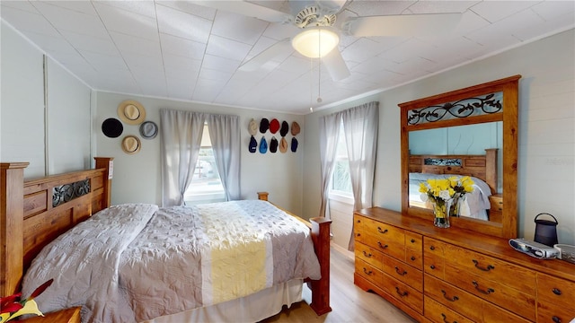 bedroom with ceiling fan and light wood-style floors