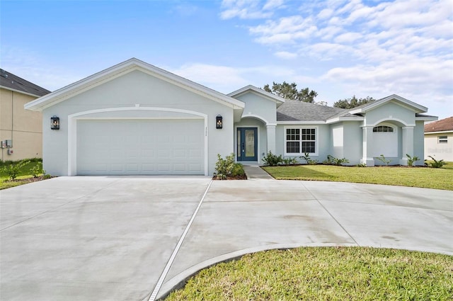 single story home with a front yard and a garage