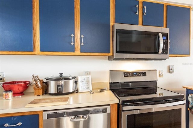 kitchen featuring appliances with stainless steel finishes and blue cabinets