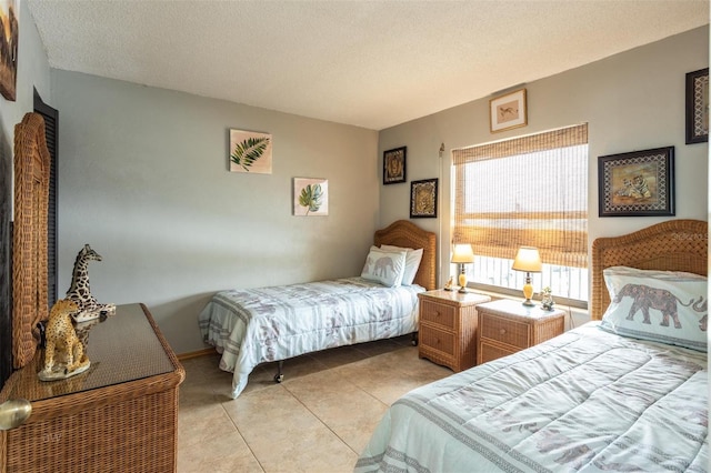 bedroom featuring a textured ceiling and light tile patterned floors