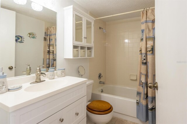 full bathroom featuring toilet, shower / bathtub combination with curtain, vanity, and a textured ceiling