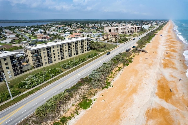 aerial view with a water view and a view of the beach