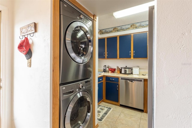 laundry area with light tile patterned flooring and stacked washer and dryer