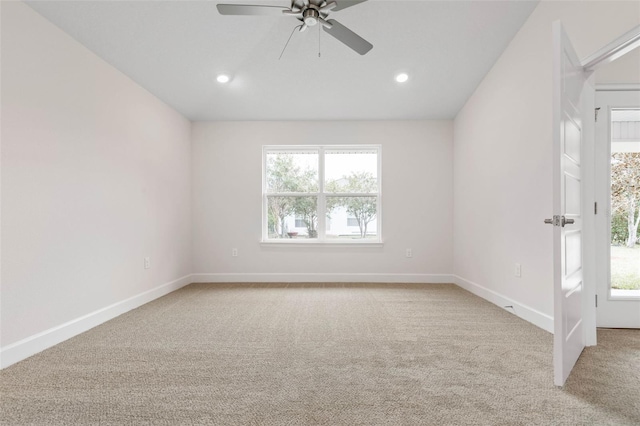 unfurnished room with light colored carpet and ceiling fan