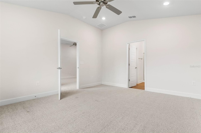 empty room with ceiling fan, light carpet, and lofted ceiling