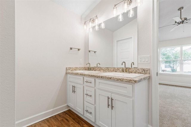 bathroom with vanity, hardwood / wood-style flooring, ceiling fan, and vaulted ceiling