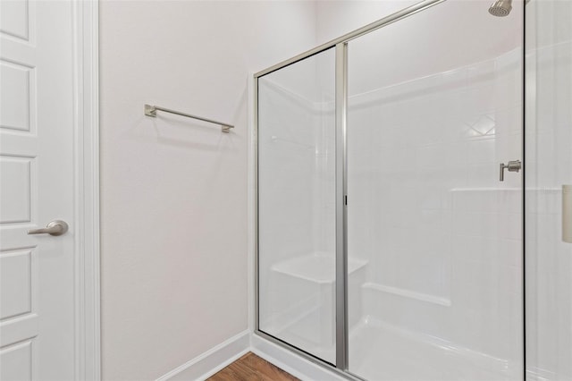 bathroom featuring wood-type flooring and walk in shower