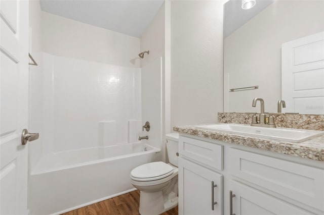 full bathroom with wood-type flooring, toilet, vanity, and  shower combination