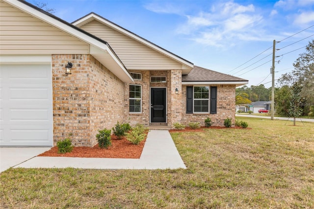 view of front of property with a garage and a front lawn