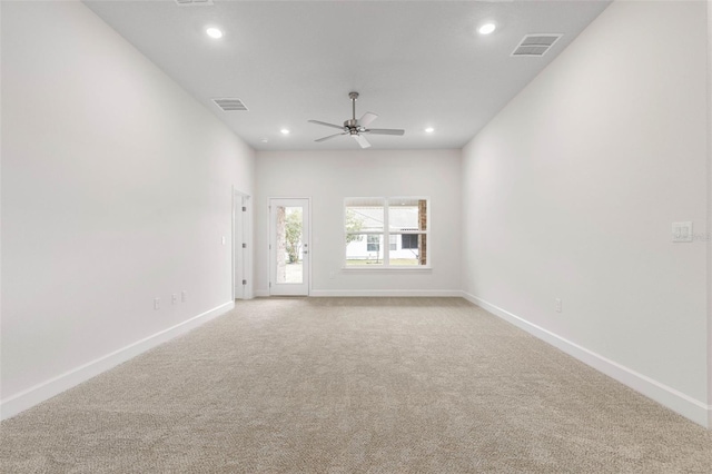 carpeted spare room featuring ceiling fan