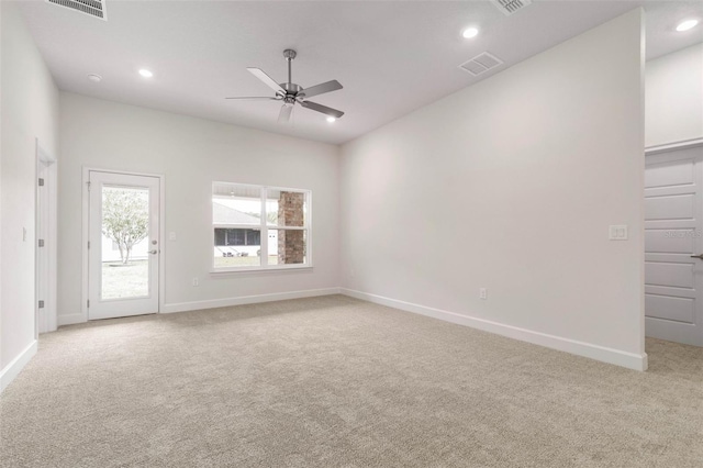 unfurnished room featuring light colored carpet and ceiling fan