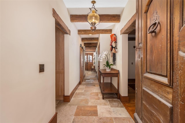 hall featuring beamed ceiling