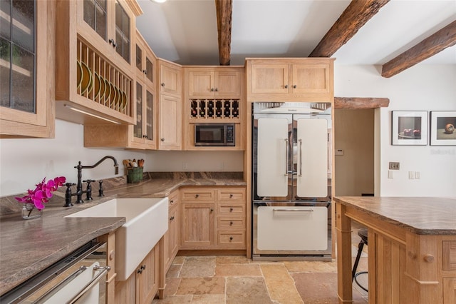 kitchen featuring built in microwave, light brown cabinets, fridge, dishwasher, and beamed ceiling