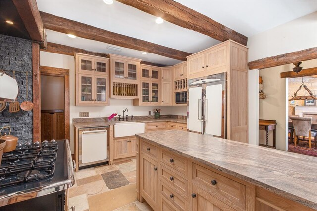 kitchen featuring beamed ceiling, sink, light stone countertops, light brown cabinets, and white appliances