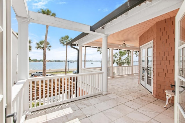 view of patio / terrace featuring a water view and french doors