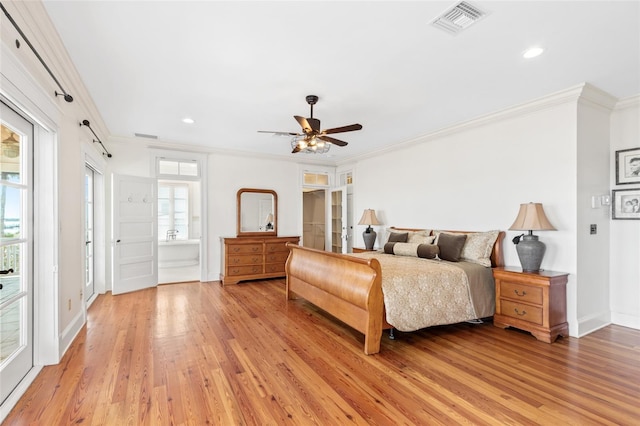 bedroom featuring multiple windows, ornamental molding, and light wood-type flooring