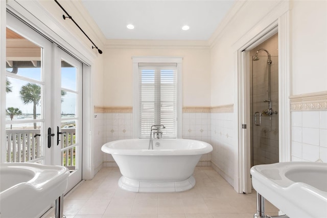 bathroom with plus walk in shower, plenty of natural light, and french doors