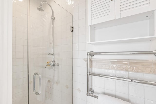 bathroom featuring a shower with shower door