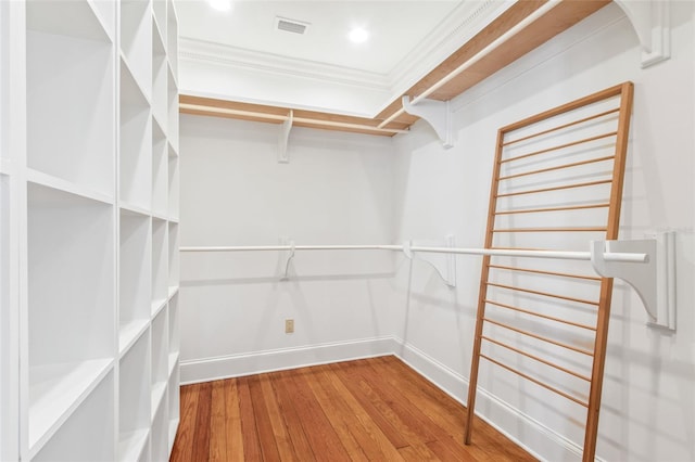 spacious closet with hardwood / wood-style floors